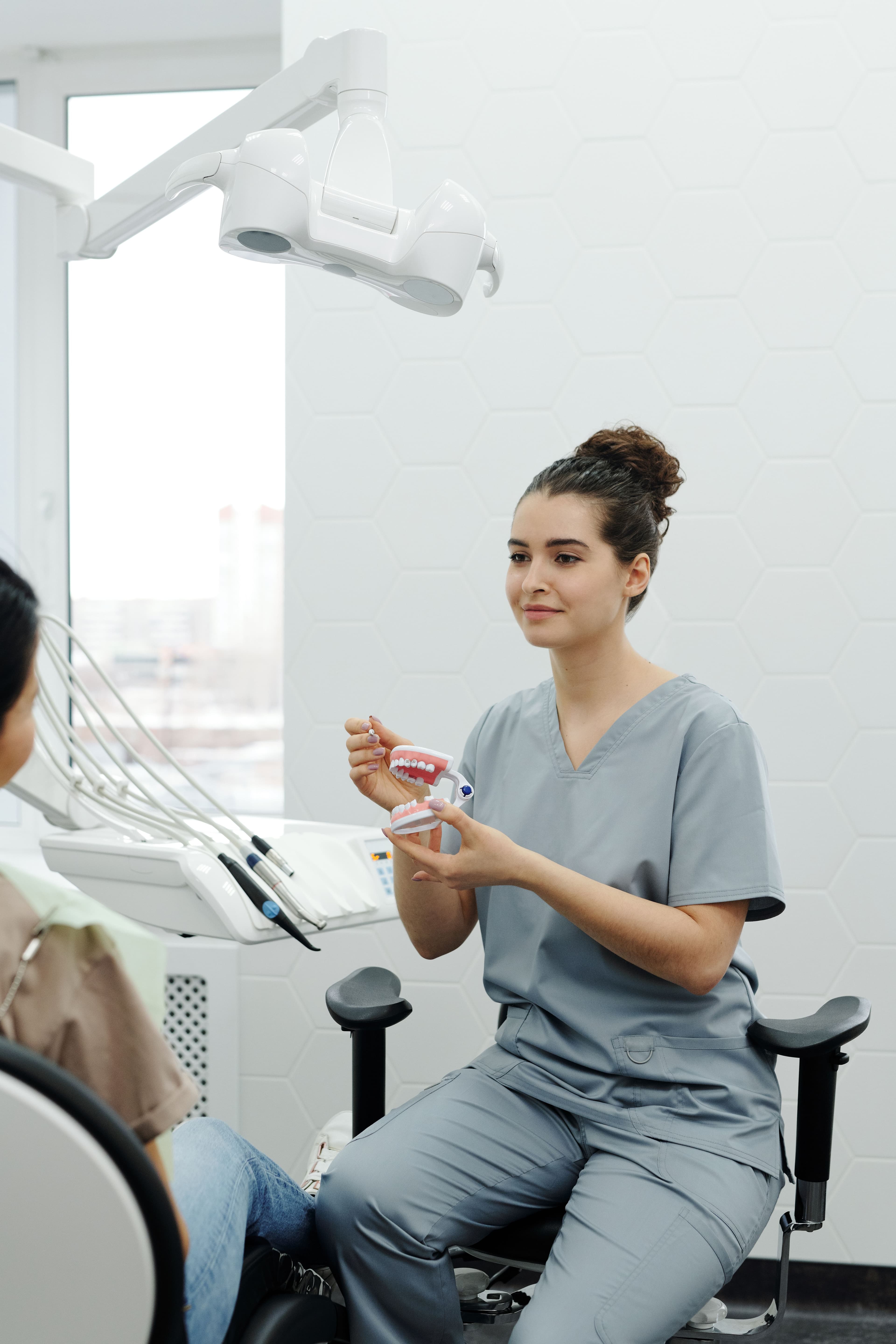 A dental hygienist at work in the practice.